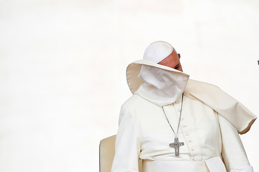 A gust of wind blows off Pope Francis' mantle during the weekly audience in Saint Peter's Square at the Vatican