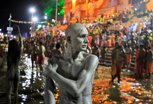 A Sadhu or a Hindu holy man applies ashes on his body after taking a dip in the waters of Shipra river at the Simhastha Kumbh Mela in Ujjain