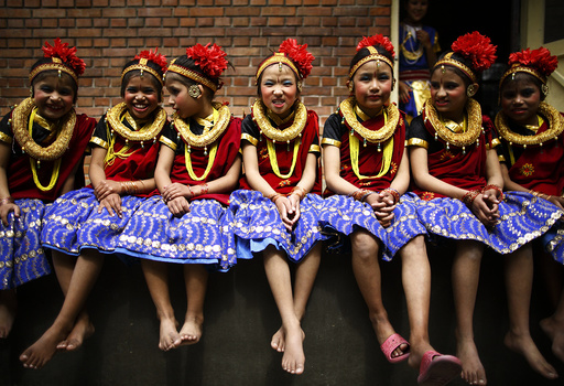 Girls take part in a function organised to mark International Women's Day at Maiti Nepal in Kathmandu