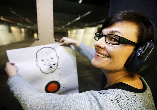 First time gun owner, Jessie Palmieri holds a target she shot with a H&K VP9 9mm gun at the Ringmasters of Utah gun range