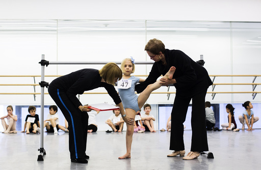 A young ballet dancer is evaluated by staff of the School of American Ballet during auditions in New York