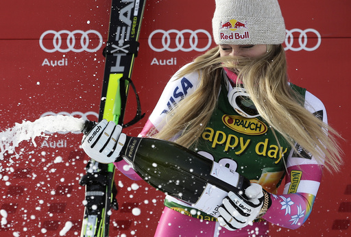 Lindsey Vonn of the U.S. sprays champagne on the podium after winning the women's World Cup Super-G skiing race in Cortina D'Ampezzo