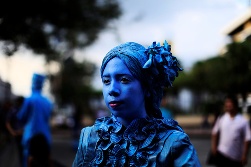 A contestant performs during a living statue contest in downtown San Salvador