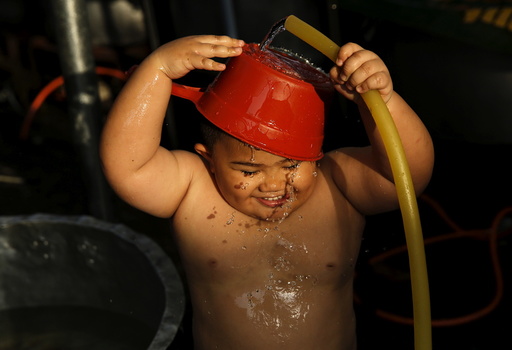 Iqal washes himself as he waits for the sun to go down during Ramadan in Kuala Lumpur
