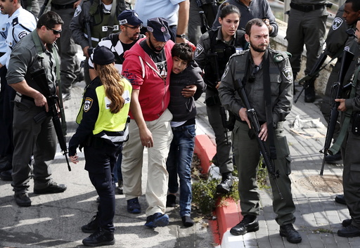Israeli police lead away a Palestinian minor in Pisgat Zeev
