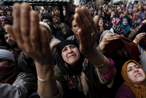 Kashmiri Muslims raise their arms upon seeing a relic of Sheikh Abdul Qadir Jeelani, a Sufi saint, being displayed at his shrine in Srinagar