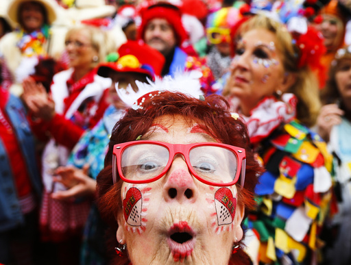 A carnival reveller celebrates the start of the carnival season in Cologne