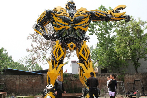 People look at a replica of a Transformer, made by a fan, in Shangqiu