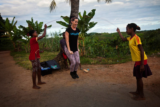 Handout photo of U.S. singer Perry joining girls playing with a jump rope during a visit to a primary rebuilt by UNICEF in Ampihaonana