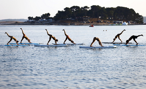 People practise Metta Float Yoga at the adriatic cost in Meduli
