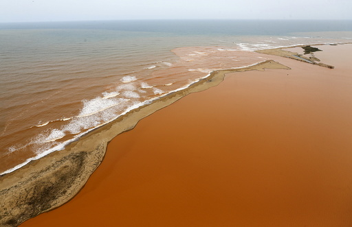 An aerial view of the Rio Doce, which was flooded with mud after a dam owned by Vale SA and BHP Billiton Ltd burst, at an area where the river joins the sea on the coast of Espirito Santo in Regencia Village