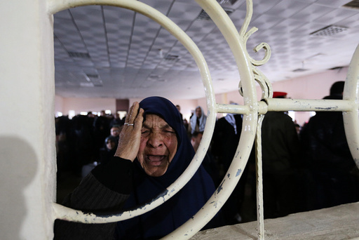 Palestinian woman reacts as she asks for a travel permit to cross into Egypt through the Rafah border crossing in Rafah in the southern Gaza Strip