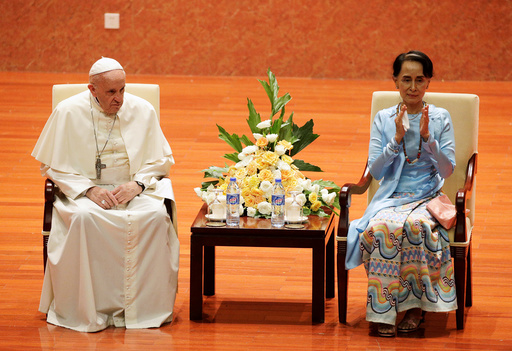 Myanmars State Counsellor Aung San Suu Kyi applauds next to Pope Francis as they attend a meeting with members of the civil society and diplomatic corps in Naypyitaw, Myanmar