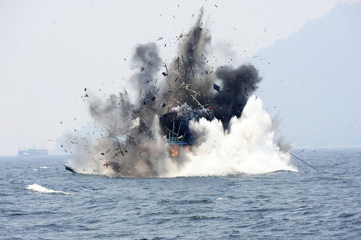 A foreign fishing boat confiscated for illegal fishing is blown up by the Indonesian Navy off of Lemukutan Island, West Kalimantan, Indonesia