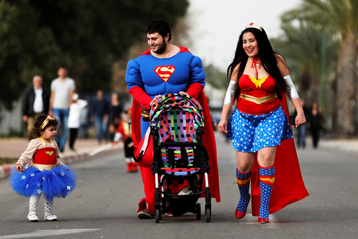 A family dressed in costumes takes part in the annual parade, marking the Jewish holiday of Purim in Ashkelon