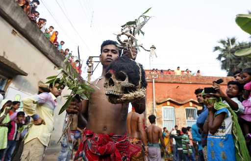 Hindu devotees carry human skulls during the annual Shiva Gajan religious festival at Kurmun village