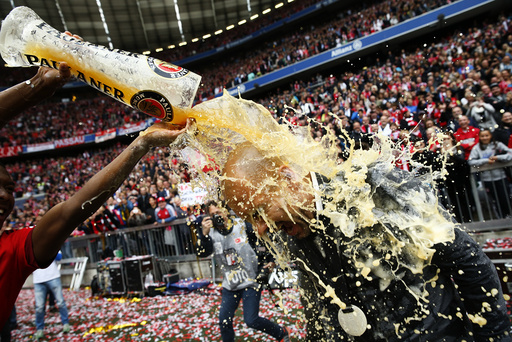 Bayern Munich's Alaba pours beer over coach Guardiola after their final German first division Bundesliga soccer match of the season against FSV Mainz 05 in Munich