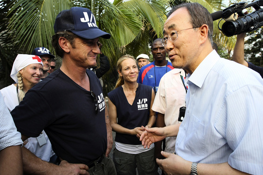 U.N. Secretary-General Ban is greeted by actor and director of J/P HRO Penn and actress Bello, member of J/P HRO, during a visit at IDP camp in Port-au-Prince