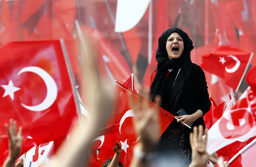 Supporters of Turkish President Erdogan wave national flags during a rally for the upcoming referendum in Konya