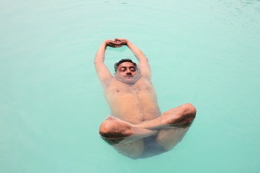 People preactice water yoga in a pool in preparation for the International Day of Yoga in Bhopal
