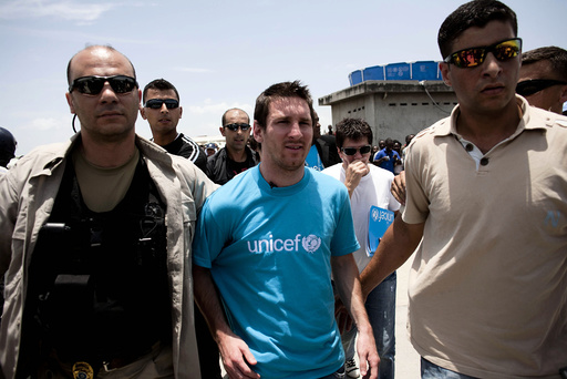 Argentinian soccer player and UNICEF Goodwill Ambassador Lionel Messi walks on a street during his visit to Port-au-Prince