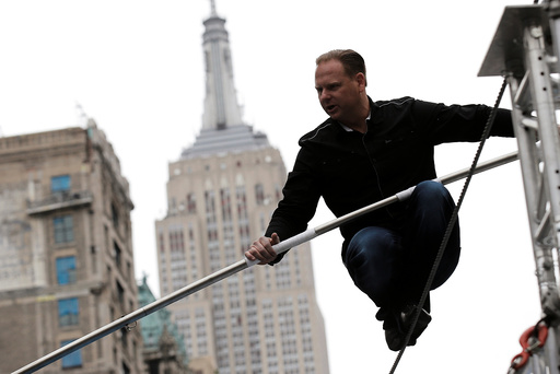 Aerialist Nik Wallenda walks a tightrope during a promotional event in New York