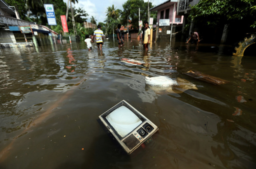A TV set floats on a flooded road in Dodangoda village in Kalutara