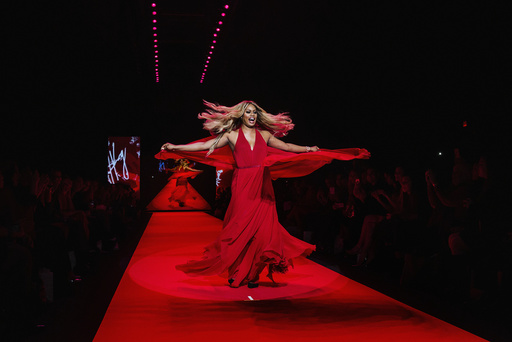 Actress Laverne Cox walks in a Donna Karan creation during a presentation of the Go Red for Women Red Dress collection during New York Fashion Week
