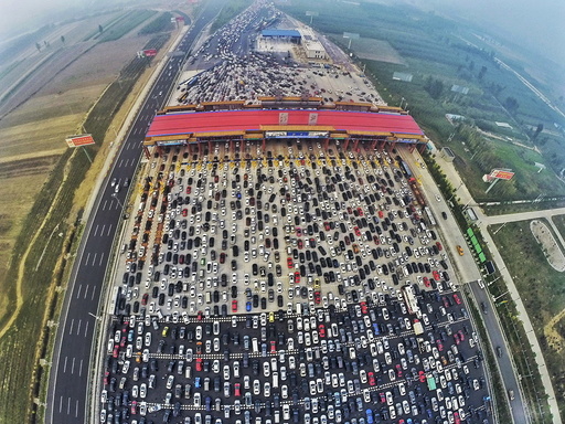 Vehicles are seen stuck in a traffic jam near a toll station as people return home at the end of a week-long national day holiday, in Beijing