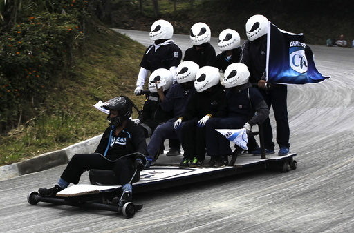 Participants descend a hill on a homemade cart during the 26th Roller Cart Festival in Medellin