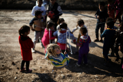 Displaced Iraqi children who fled the Islamic State stronghold of Mosul with their families play at Khazer camp