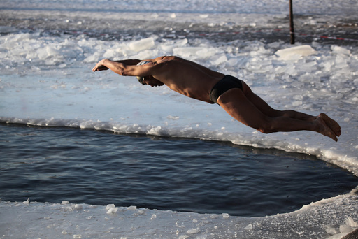Winter swimmer dives into icy waters at Beiling Park in Shenyang