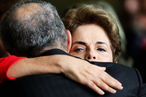 Brazil's former President Dilma Rousseff, who was removed by the Brazilian Senate from office earlier, is greeted by former defense minister Aldo Rebelo at the Alvorada Palace in Brasilia