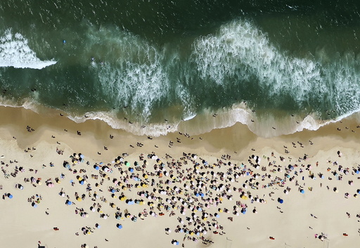 People enjoy the sunny weather at Ipanema beach in Rio de Janeiro