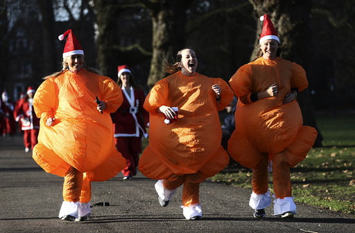 Participants dressed as turkeys take part in a Santa Run at Battersea Park in London