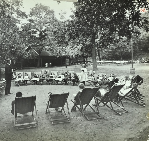 Reading lesson outside, Bostall Woods Open Air School, London, 1907. Artist: Unknown.