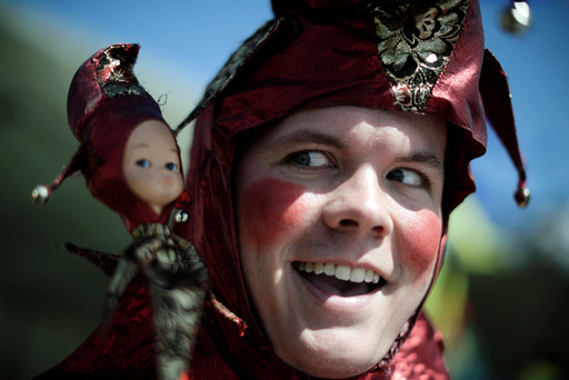 Jamie Oberg clowns for the camera as a court jester at the St Ives Medieval Fair in Sydney, one of the largest of its kind in Australia