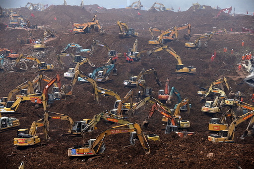 Excavators are seen during rescue operations at an industrial estate hit by a landslide in Shenzhen