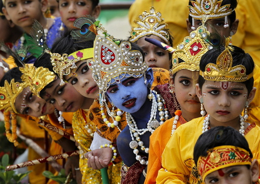 Schoolchildren dressed as Hindu Lord Krishna wait to perform during celebrations on the eve of the Janmashtami festival in Chandigarh