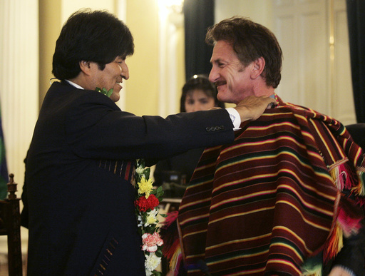 Actor Sean Penn receives a poncho from Bolivian President Evo Morales in La Paz