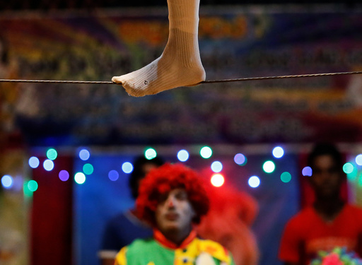 A member of Sakura circus team walks on a wire during the second day of a one week show in Padukka