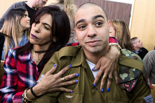 Israeli soldier Elor Azaria is embraced by his mother at the start of is sentencing hearing at a military court in Tel Aviv, Israel