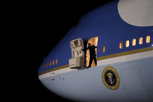 An Air Force personnel open the door of the the Air Force One as U.S. President Barack Obama arrive at Joint Base Andrews from New Jersey and New York, in Maryland