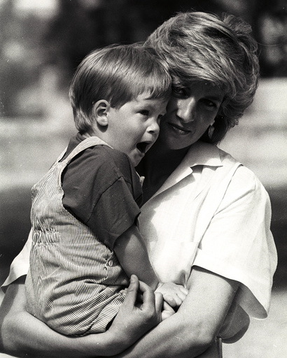 Prince Harry yawns as his mother Princess Diana holds him during a morning picture session at Marivet Palace