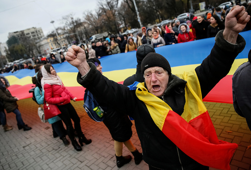 People take part in a rally against Moldova's President-elect Dodon representing the Socialist Party in Chisinau
