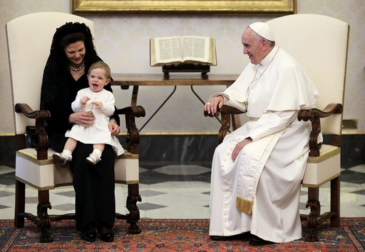 Pope Francis looks at a smiling Princess Leonore during a meeting with Sweden's Queen Silvia at the Vatican