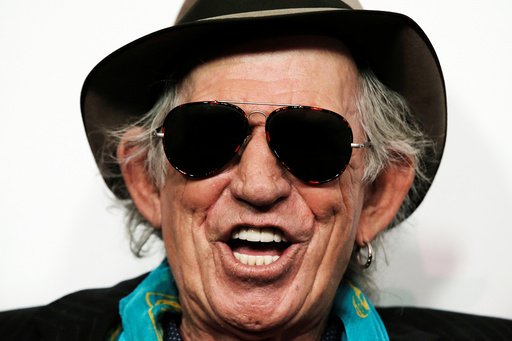 Keith Richards of The Rolling Stones poses for photographers as the band arrives for the opening of the new exhibit Exhibitionism: The Rolling Stonesin New York
