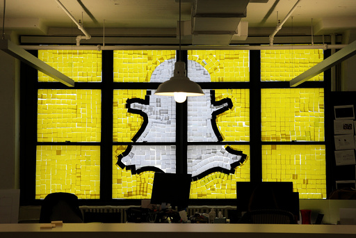 Snapchat logo image created with Post-it notes is seen in the windows of Havas Worldwide offices at 200 Hudson street in lower Manhattan, New York during Post-it note war