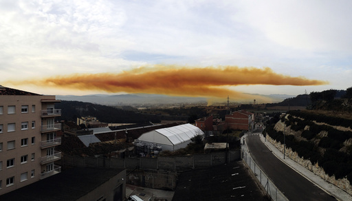 Orange toxic cloud is seen over the town of Igualada, near Barcelona, following an explosion in a chemical plant