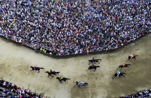 Horses race during the general practice session for the Palio di Siena horse race in Siena